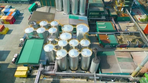 Drone aerial view of palm kernel oil tanks, factory, warehouse and stack Video stock 252348194