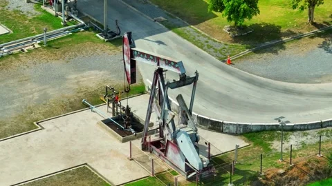 Drone aerial view of a pumpjack working at an oil extraction site. Stock Footage 330777199