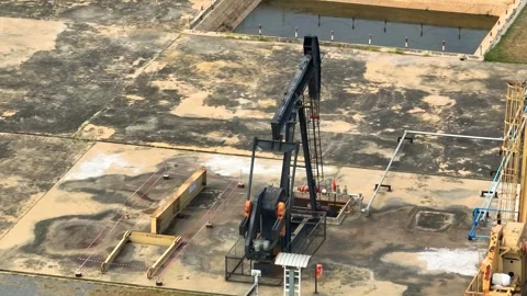 Drone aerial view of a pumpjack working at an oil extraction site. Stock Footage 330777252
