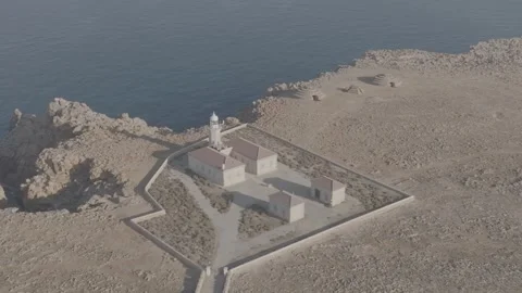 Drone aerial view of Punta Nati Lighthouse in Menorca, Balearic Islands - DLog Stock Footage 246499056