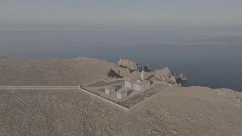 Drone aerial view of Punta Nati Lighthouse in Menorca, Balearic Islands - DLog Stock Footage 246499115