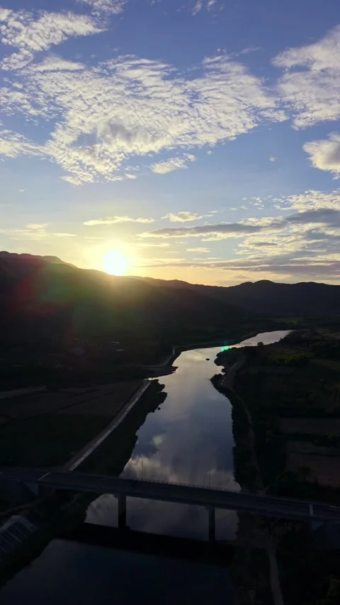 Drone aerial view of a river bridge at sunset 스톡 동영상 336610406