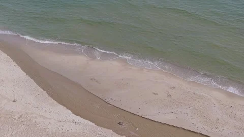 Drone aerial view of sandy beach with coastal water stream Stock Footage 321046796