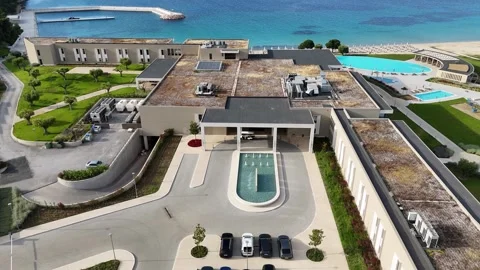 Drone aerial view of seaside resort hotel complex with pools Greece Stock Footage 327790071