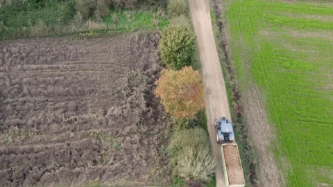 Drone aerial view of a tractor driving on a farm track Stock-Footage 299701586