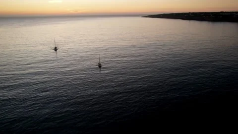 Drone aerial view of two pleasure vessels at Cascais Bay, Portugal at sunset Stock Footage 252269511