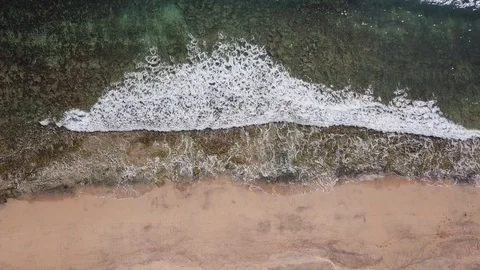 Drone aerial view of waves breaking on sand beach in Porto Santo island Stock Footage 116984602
