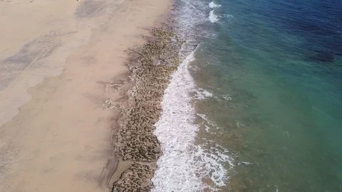 Drone aerial view of waves breaking on sand beach in Porto Santo island Stock Footage 116984782