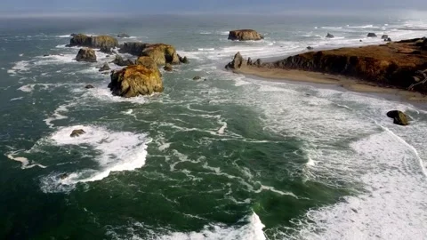 Drone aerial view of waves splashing coastal rock formations Stock Footage 229341561