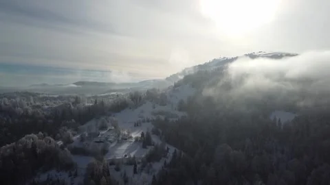 Drone Aerial View of Winter Mountains Rising Above the Fog Stock Footage 324565732