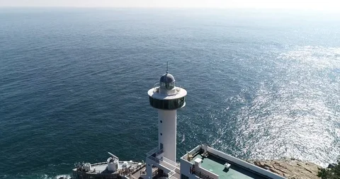 Drone aerial view of Yeongdo lighthouse at Taejongdae scenic spot in Busan Stock Footage 100968077