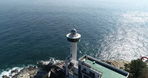 Drone aerial view of Yeongdo lighthouse at Taejongdae scenic spot in Busan Stock Footage 100968084