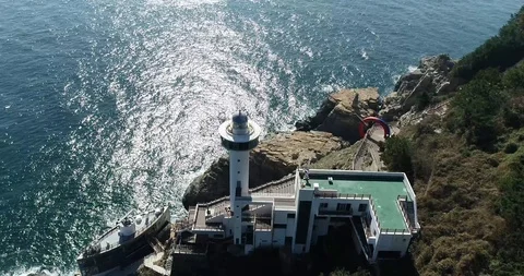 Drone aerial view of Yeongdo lighthouse at Taejongdae scenic spot in Busan Stock Footage 100968104
