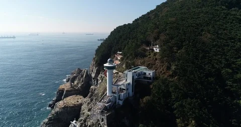 Drone aerial view of Yeongdo lighthouse at Taejongdae scenic spot in Busan Video stock 100968249
