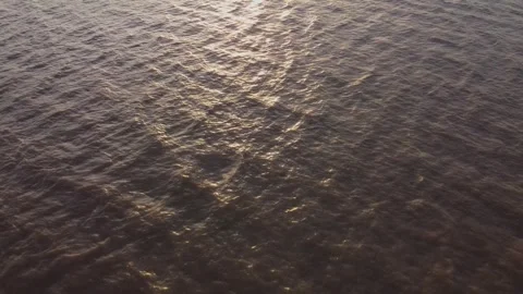 Drone, aerial, water, water surface, sunset, sun reflection, sunlight Stock Footage 346380343