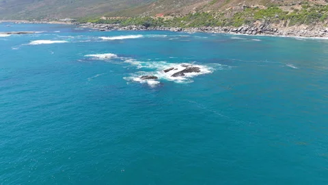 Drone Aerial of Waves Breaking Over Rocky Outcrop in Atlantic Ocean Stock Footage 330317792