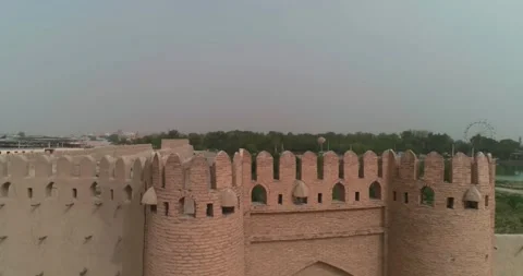 A drone from afar flies around the wall of the fortress in Bukhara near the Stock Footage 245681875