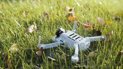 Drone after crash with broken camera module on green grass Stock Footage 165144321