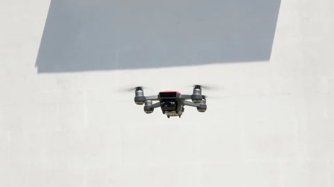 Drone in the air. Rotating drone in blue sky 스톡 동영상 112662301