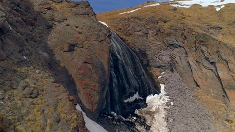 Drone alpine winter waterfall glacial fall Girl's braids cascade Caucasus Elbrus Stock Footage 128033826