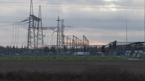 Drone and ground-level footage reveal a transformer station against a sunse.. Stock Footage 259379177