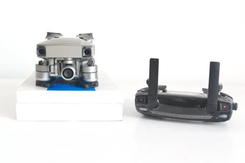 Drone and remote control next to some books in a drone pilot classroom Stock Photos