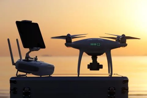Drone and remote controller in sunset Stock Photos