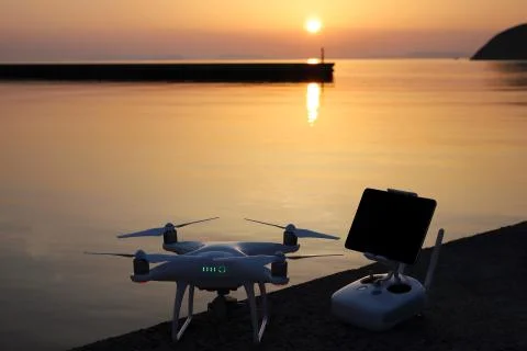 Drone and remote controller in sunset Stock Photos