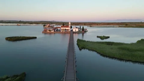Drone Approach Along the Bridge to Porto Lagos Monastery at Golden Hour Stock Footage 340259010