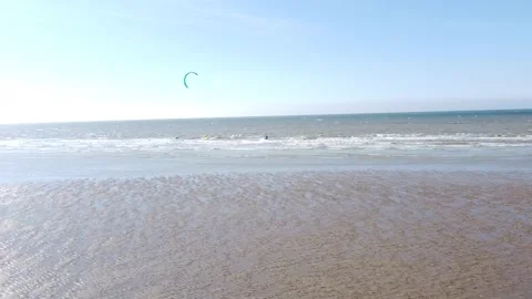 Drone approach from beach to kitesurfer riding in the sea in Normandy, France Stock Footage 346698066