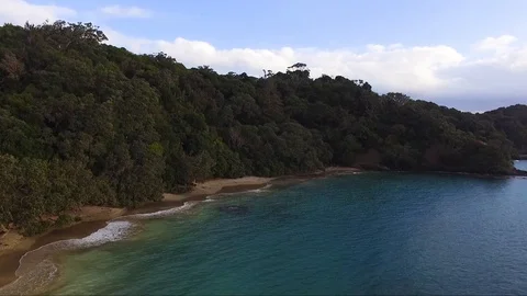 Drone approach of a Beautiful secluded beach with thick bush. Stock Footage