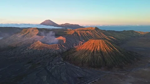 Drone Approach to Mount Bromo and Volcanic Peaks in Red Dawn Light, Indonesia Stock Footage 343734027
