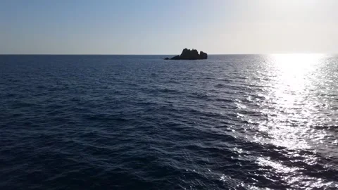 Drone Approach to Solitary Rocky Islet in Endless Deep Blue Sea Stock Footage 315073724