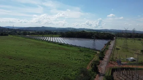 Drone approach towards a triangular photovoltaic farm integrated into the rural Stock Footage 332178873