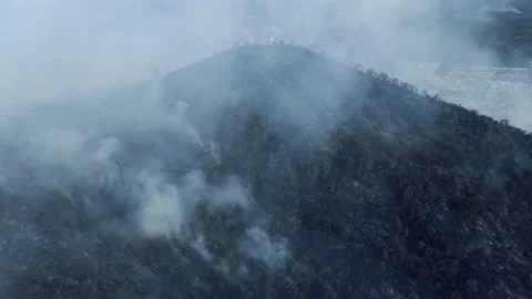 A drone approaches a mountain on fire 4k Stock Footage 151807355