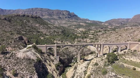 Drone approaches Seven Moons Bridge over a rocky ravine near Alcoy, Spain. Stock Footage 337877378