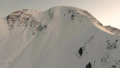 Drone Approaches Snow Capped Peak in Italian Alps Stock Footage 229795300