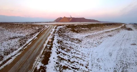 Drone approaching to abandoned construction zone with sand heap and digger  Stock Footage 102095013