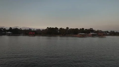 Drone approaching docks while birds are flying around on Mobile Bay, Alabama Stock Footage 332629630