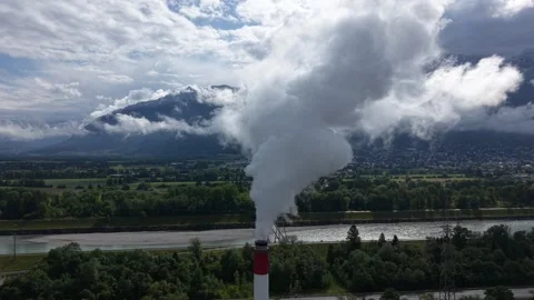 Drone approaching industrial chimney emitting heavy steam emissions Stock Footage 335038301
