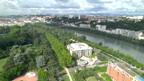 Drone Approaching Interpol Headquarters Along River and Park Stock Footage 324009481