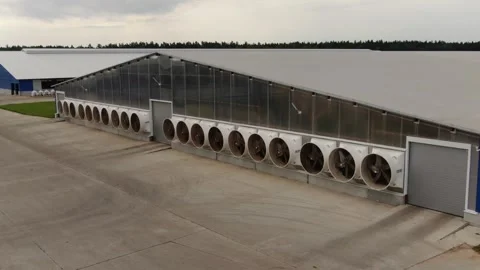 Drone approaching modern farm building with ventilation fans Stock Footage 333186963