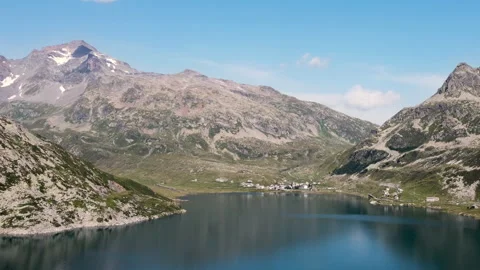 Drone approaching Montespluga town with surrounding mountains - Italian Alps Stock Footage 319207111