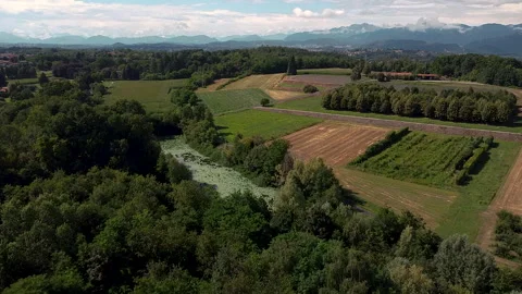 Drone approaching a pond inside farmlands in Lombardy Northern Itly Видео 247316761