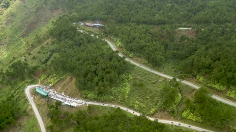 Drone approaching roadside stop on mountain pass with motorbikes Video stock 313798258