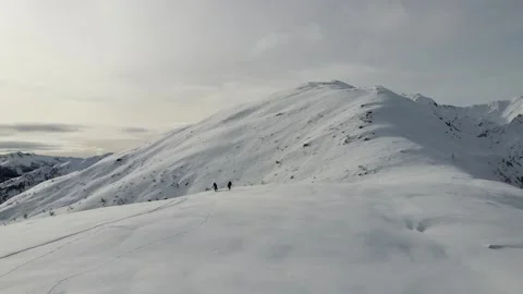 Drone approaching two ski tourers standing on mountain ridge Stock Footage 145801347