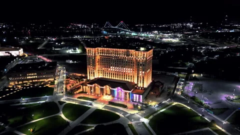 Drone approaching the vibrant, glowing Michigan Central station, night in Видео 293660647