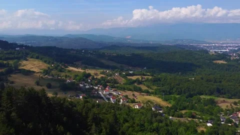 Drone Arc Over Pine Forest Revealing Mountain Villages and Scenic Landscape Stock Footage 313548232