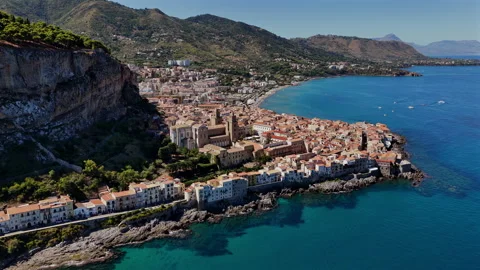 Drone Arc View of Cefalù Cathedral with La Rocca Rock and Coastline, Sicily Stock Footage 319815707