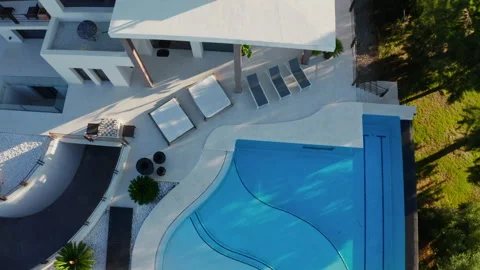 Drone Arcing Around Infinity Pool Of Luxury Property Video stock 174332448
